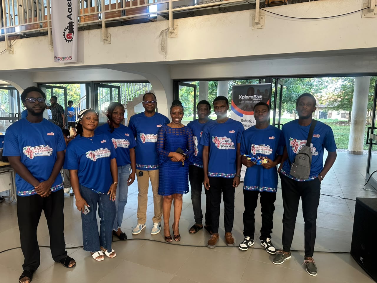 Team GCU members in matching blue shirts standing together at the competition venue